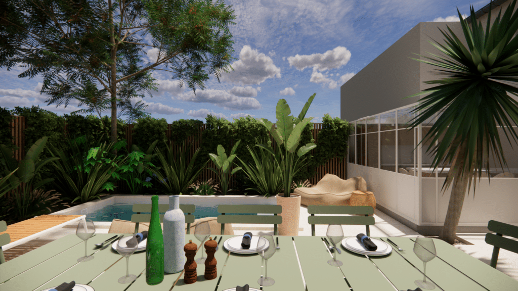 Table dressée sur une terrasse avec piscine, plantes exotiques et décor moderne sous un ciel bleu nuageux.