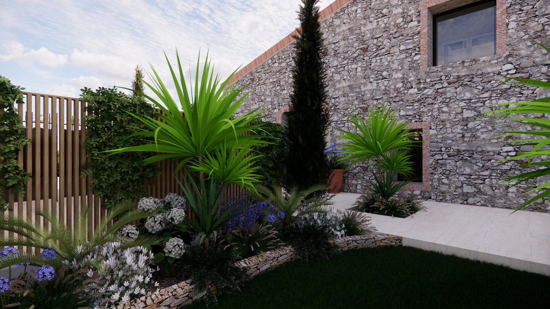 Aménagement paysager avec plantes tropicales, fleurs et muret en pierre devant une maison rustique.